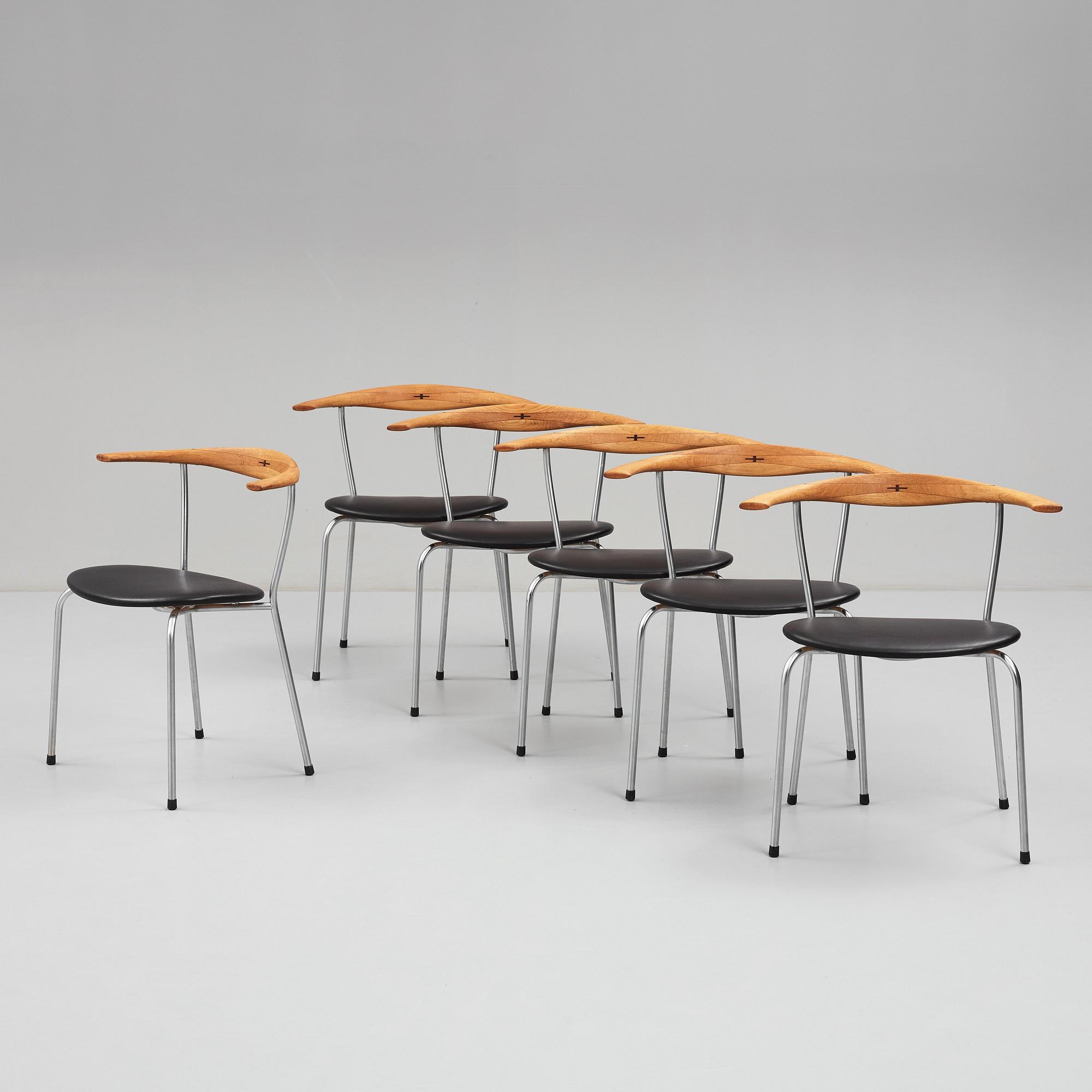 Hans J. Wegner, a set of six "JH-701" oak and black leather chairs by Johannes Hansen, Denmark.