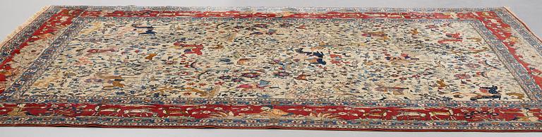 A CARPET, a semi-antique Teheran probably, a figural part silk, ca 347,5-345,5 x 242 cm.