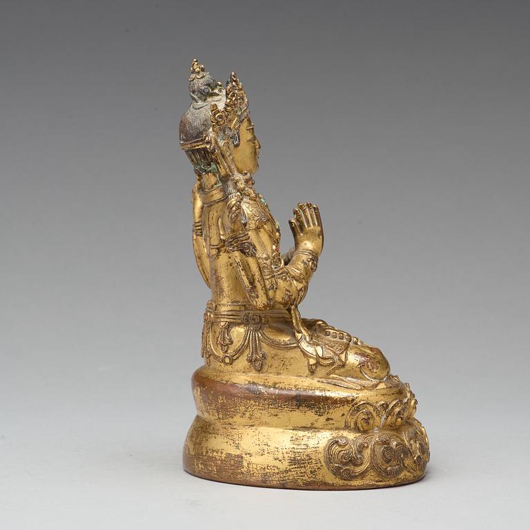 A gilt copper alloy four armed Sadaksari Avalokiteshvara, Tibet/Nepal, 15th Century or older.