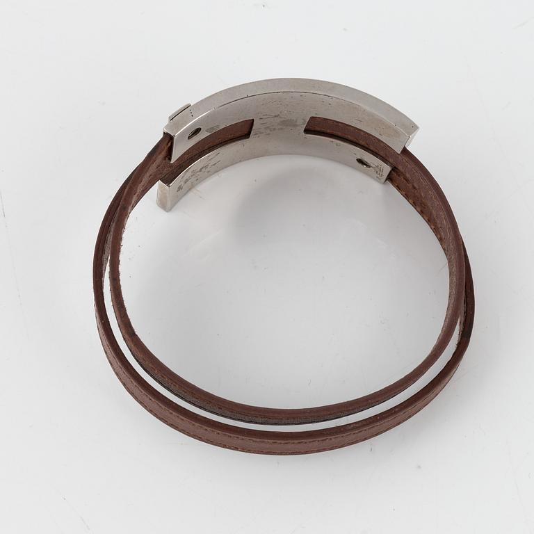 Hermès, a brown leather and palladium metal 'Pousse Pousse' bracelet.