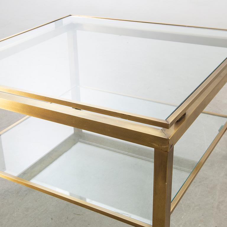 A brass and glass top coffee table.