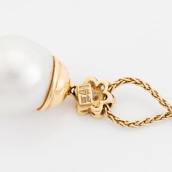 An 18K gold and cultured South Sea pearl pendant set with round brilliant-cut diamonds.