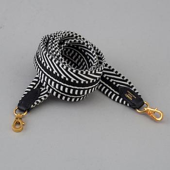 A bag strap by Hermès.