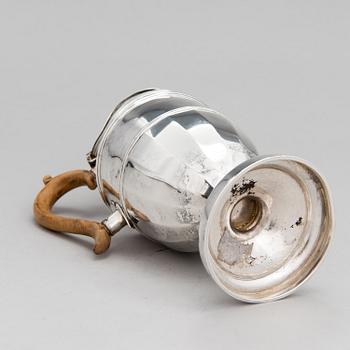 A sterling silver pitcher with wooden handle, London 1903.