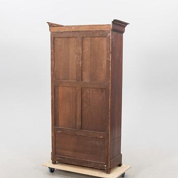 A walnut display cabinet around 1900.