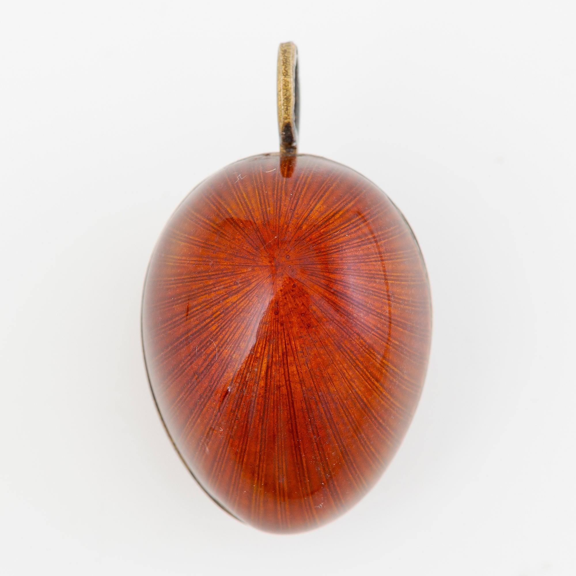 Pendant, in the form of an egg, A. Tillander, gilded silver and red enamel, Finland 1977.