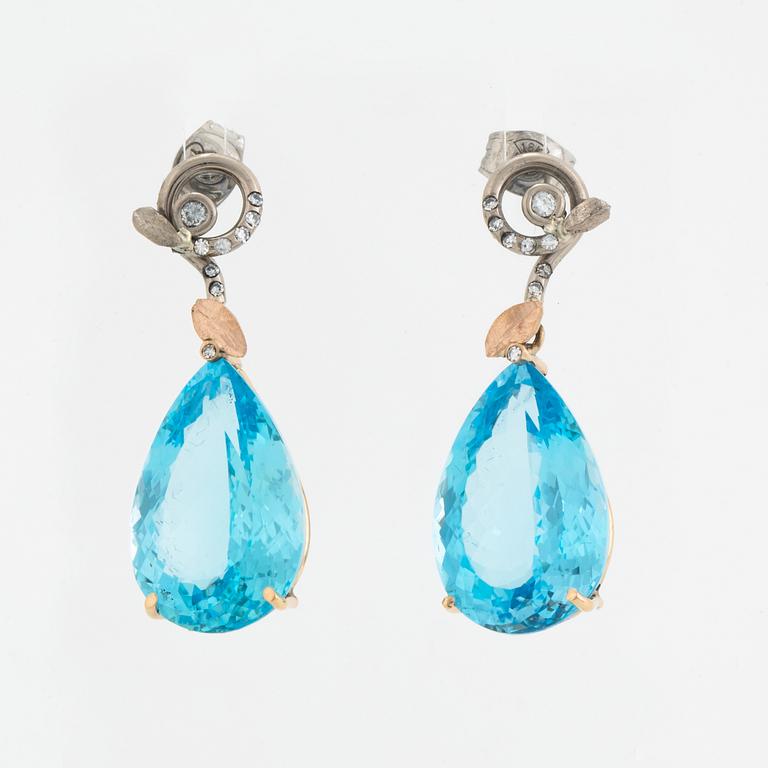 Drop shaped blue topaz and diamond earrings.