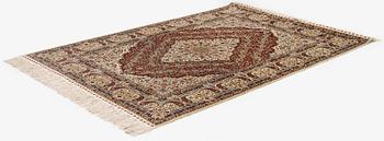 A semi-antique silk Hereke rug, West Anatolia, c. 180 x 121 cm.