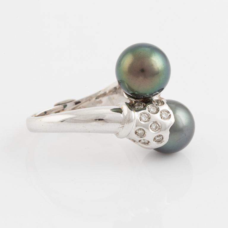 Cultured black pearl and brilliant cut diamond cross over ring.