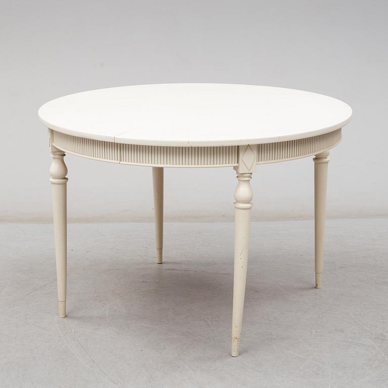 Four chairs with dinner table, late 20th Century.
