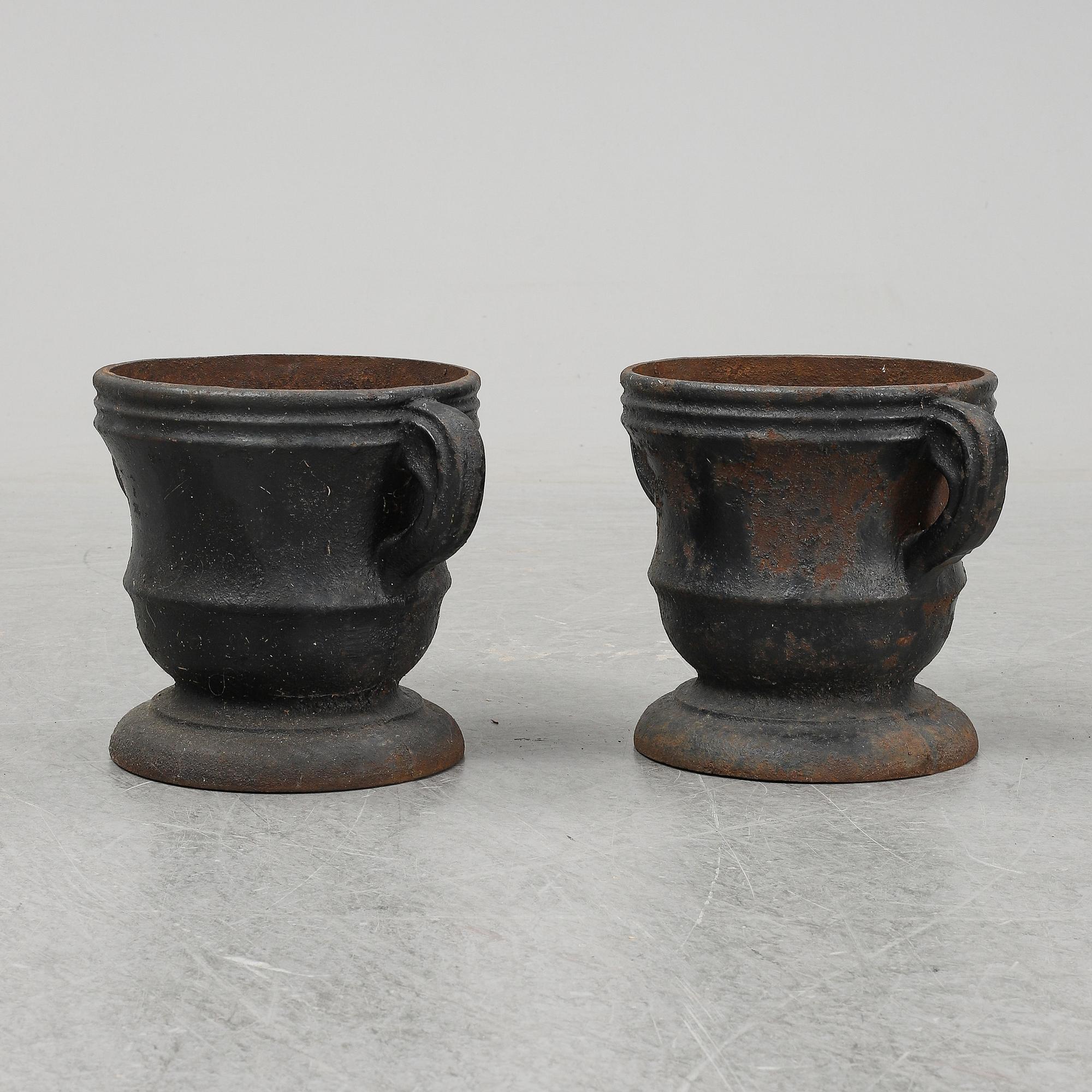 A 19th  century pair of cast iron flower pots.