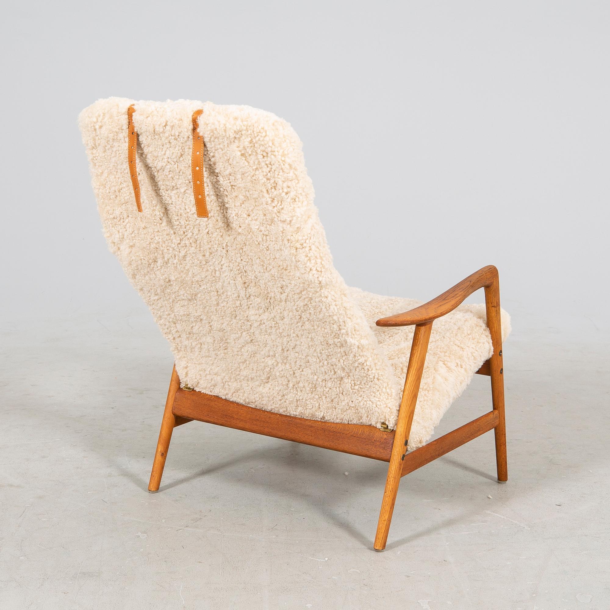 An Alf Svensson Contour-Set 327 sheepskin armchair.