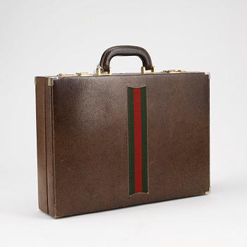 GUCCI, a brown leather briefcase.