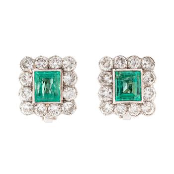 A pair of 14K gold earrings set with step-cut emeralds.