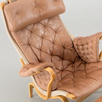 A "PERNILLA" ARMCHAIR WITH OTTAMAN BY BRUNO MATHSSON BY DUX.