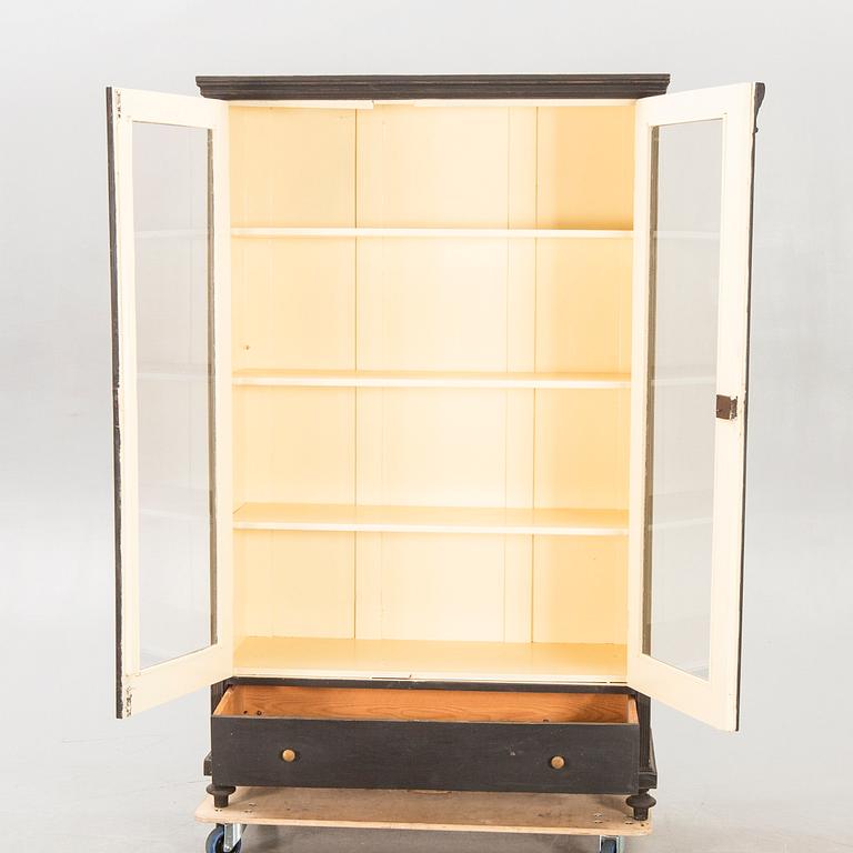 A painted early 1900s display cabinet.