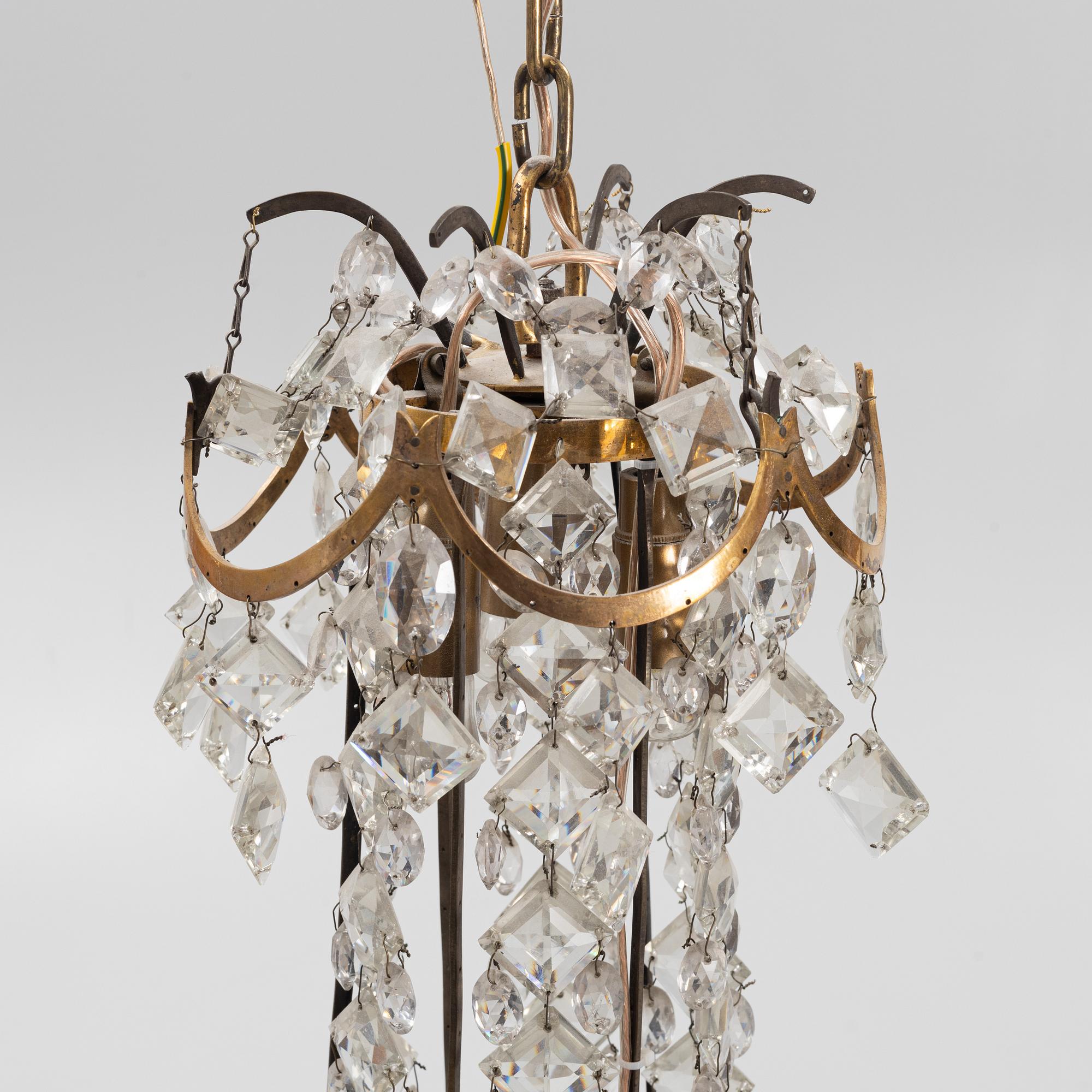 A Louis XVI gilt-brass and cut glass nine-light chandelier, circa 1800.