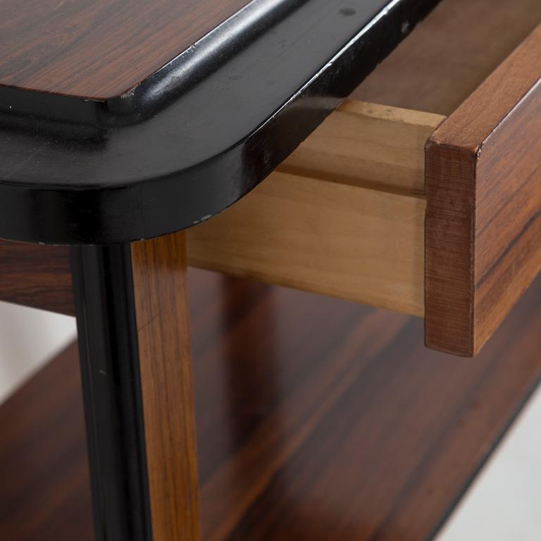 A second half of the 20th century rosewood mirror with table.