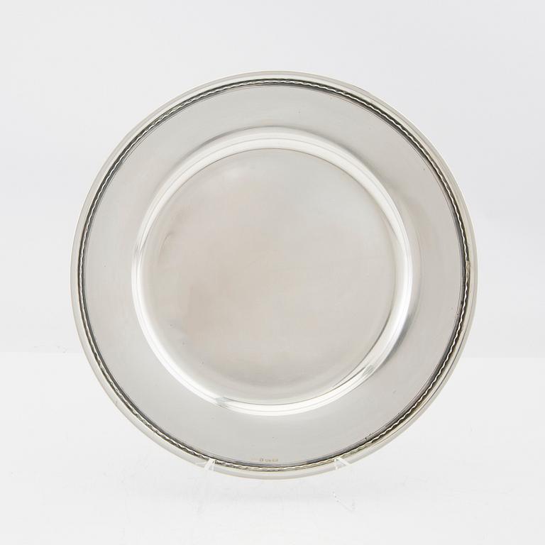 A set of 12 silver plates mark of GAB Stockholm 1963, total weight 6000 grams.