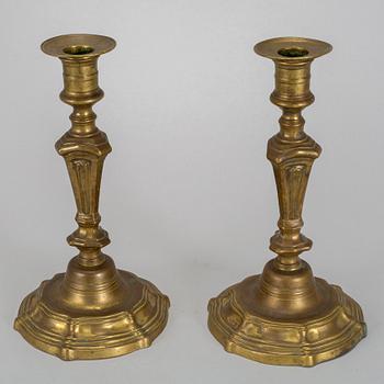 A pair of 18th century bronze candlesticks.