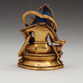 A Sino-Tibetan gilt bronze figure of Kubera, 18th Century.