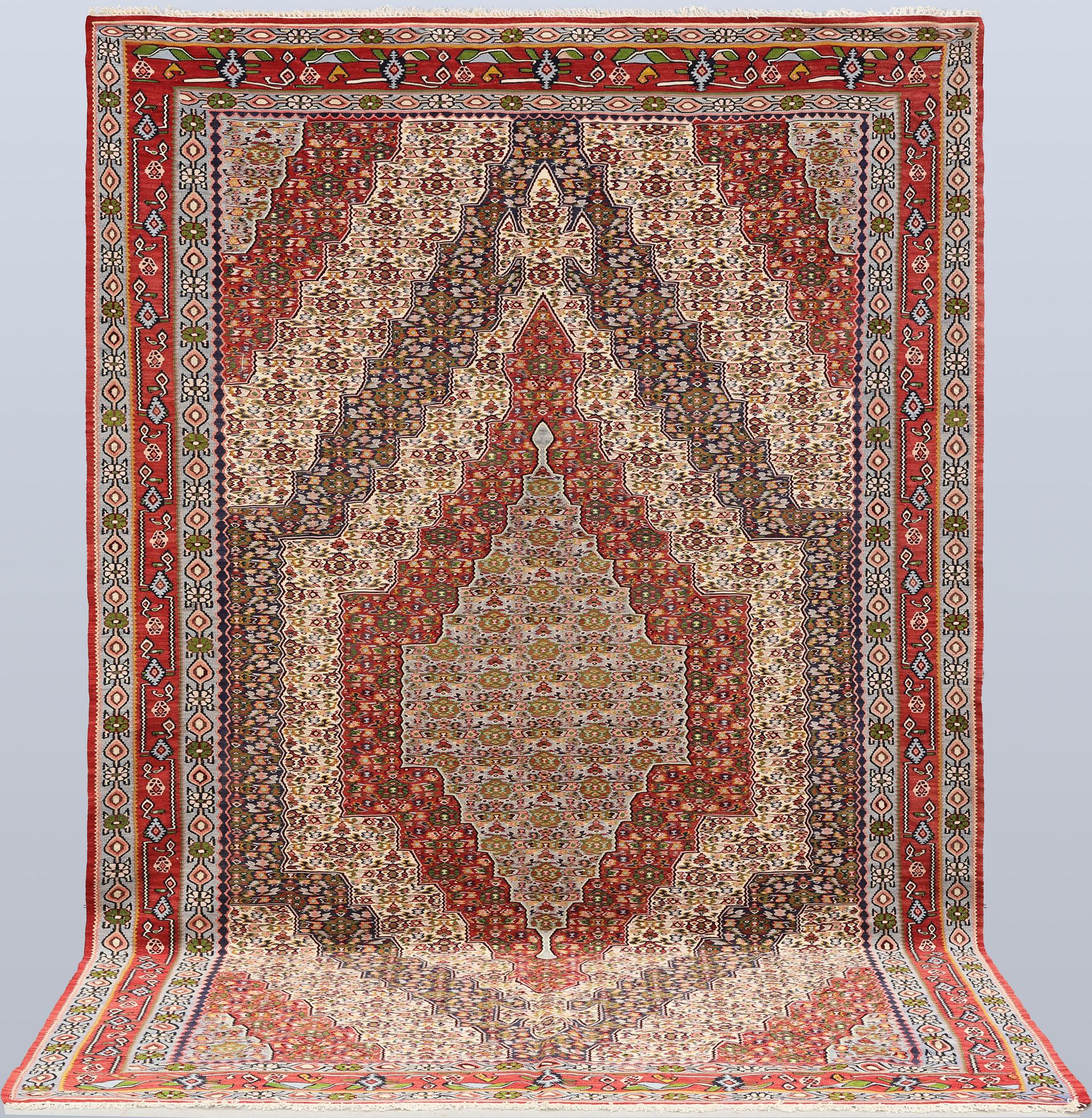 A Kelim Senneh carpet, 300 x 196 cm.