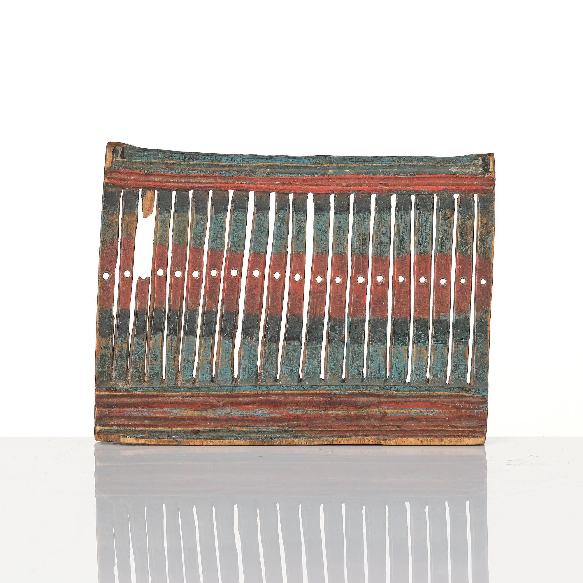 A Swedish carved and polychrome painted weaving tool from Hälsingland, 19th century.