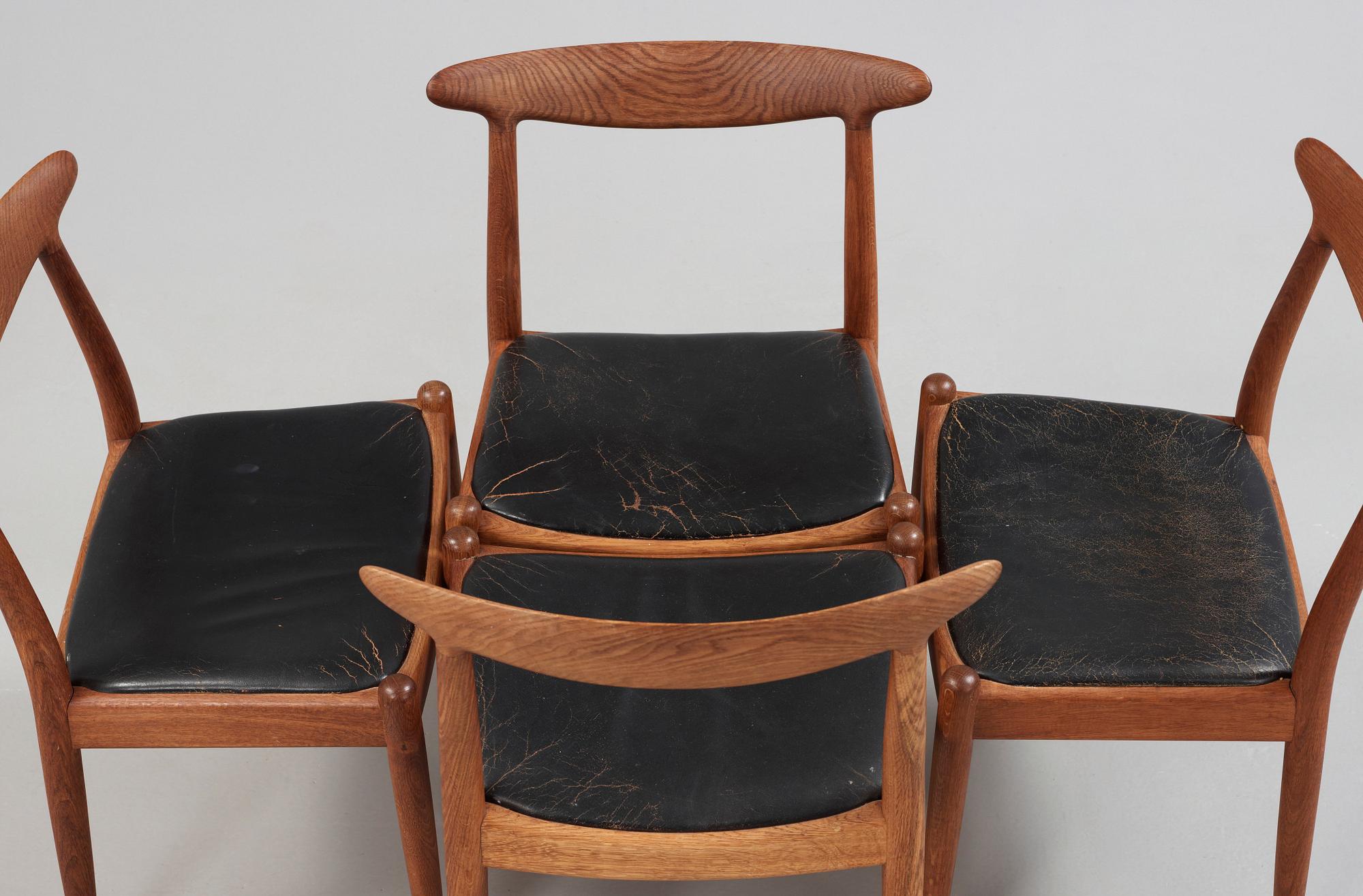 A Hans J Wegner oak dinner table 'AT 312' and four oak and black leather chairs, C M Madsen, Denmark 1950-60's.