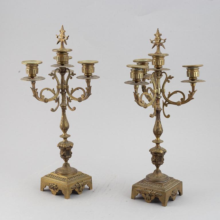 A mantle clock with pair of candelabra, late 19th century.