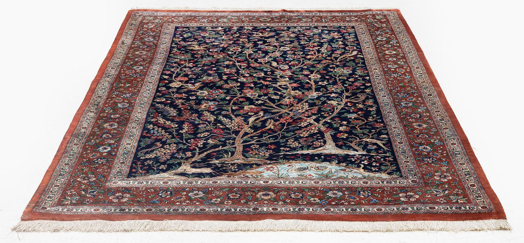 A signed pictoral silk Qum rug, c. 203 x 127 cm.