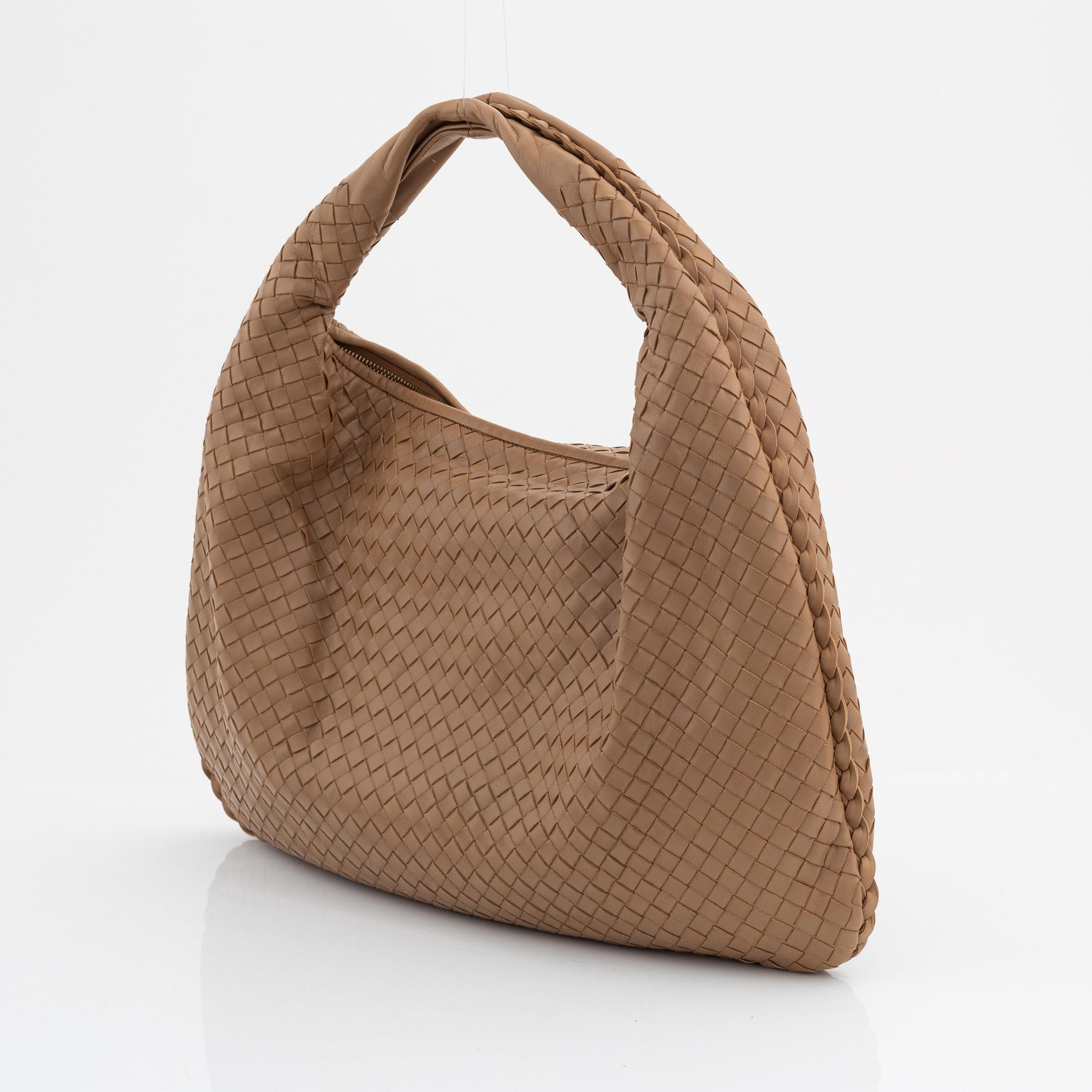 Bottega Veneta, a beige intrecciato leather bag.
