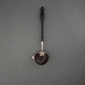 A silver and coconut rococo soup spoon, Sweden 18th century, marked LS.