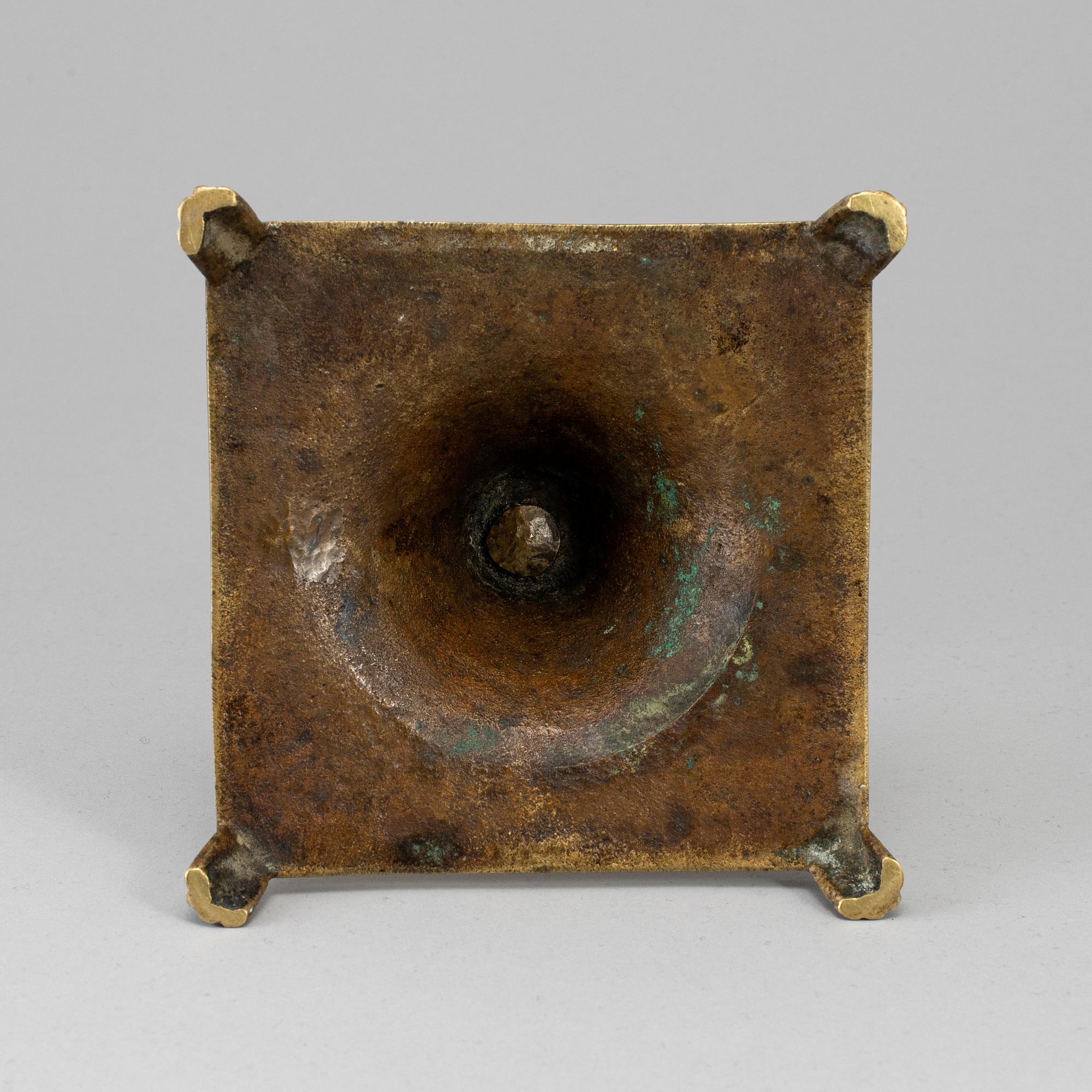 A 17th century bronze candlestick.