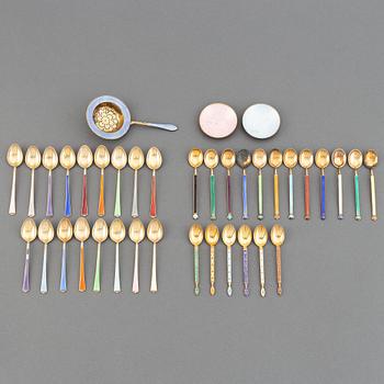 A mixed lot of 35 silver spoons, a tea strainer and two small dishes, parcel-gilt guilloché enamel, Norway, 20th century.