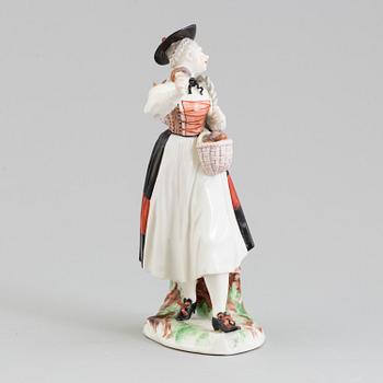 A Nymphenburg porcelain figure of a mushroom sales woman, Germany, 20th Century.