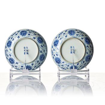 A pair of blue and white 'lotus' dishes, Qing dynasty, Tongzhi mark and of the period period (1862-74).