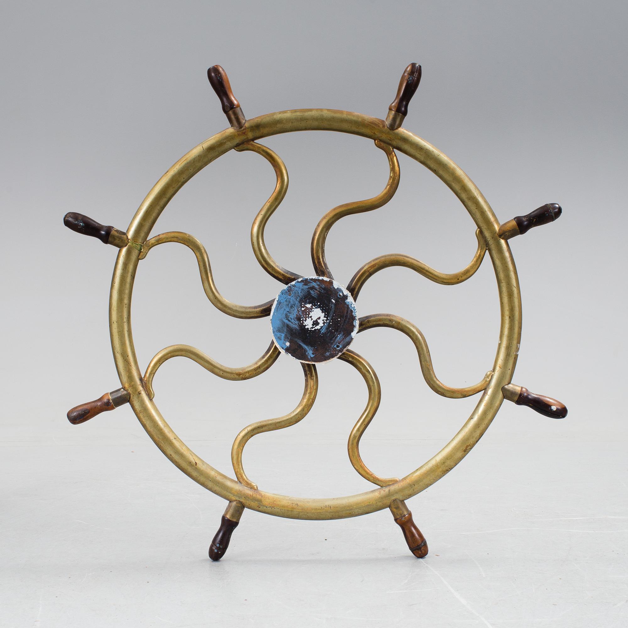 A ship steering wheel, about 1900.