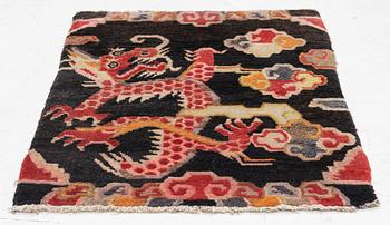 An semi-antique Tibet rug, 79 x 56 cm.