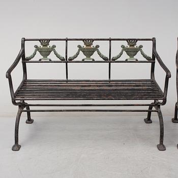GARDEN SOFAS, a pair, cast iron, empire style, late 19th century.