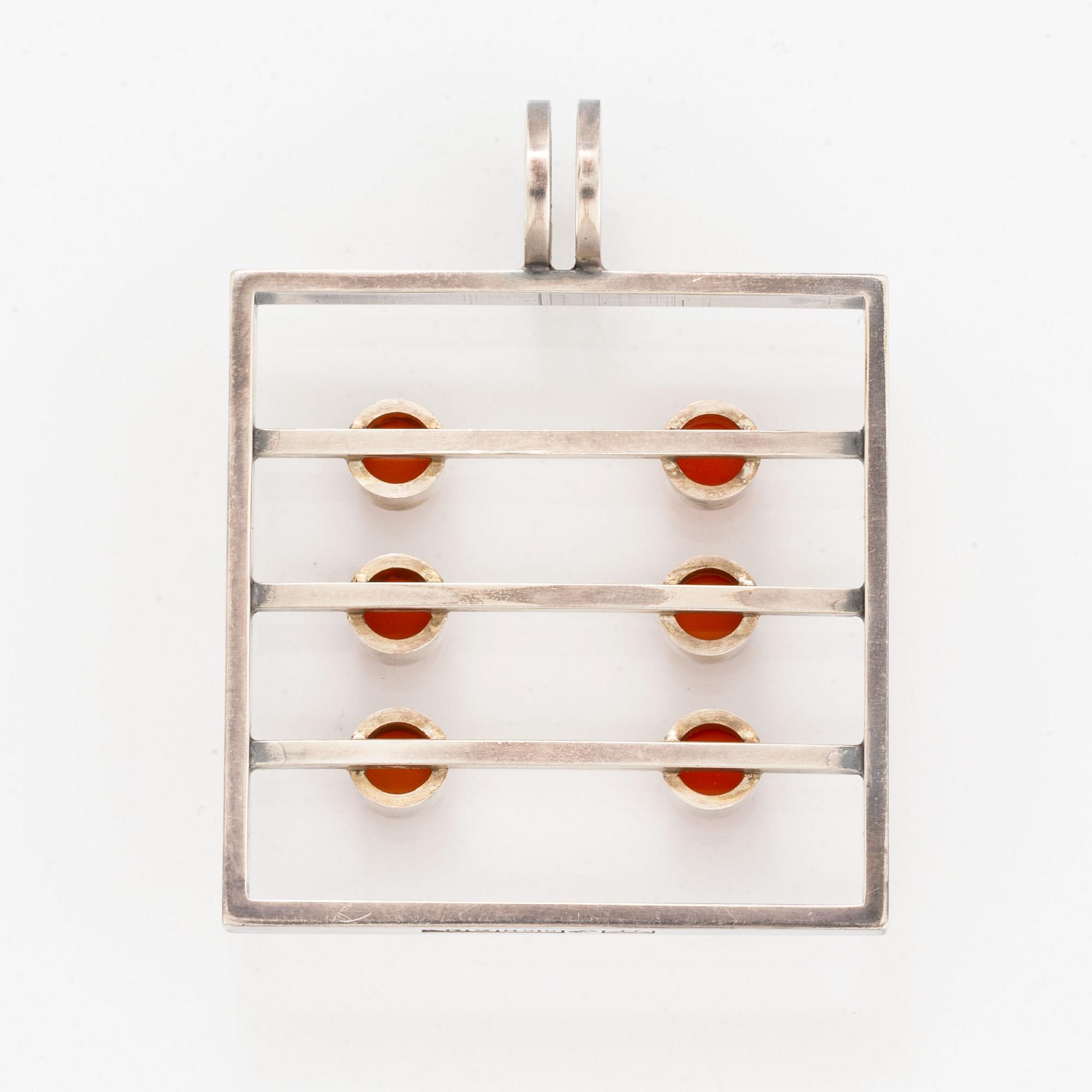 A silver pendant set with carnelian.