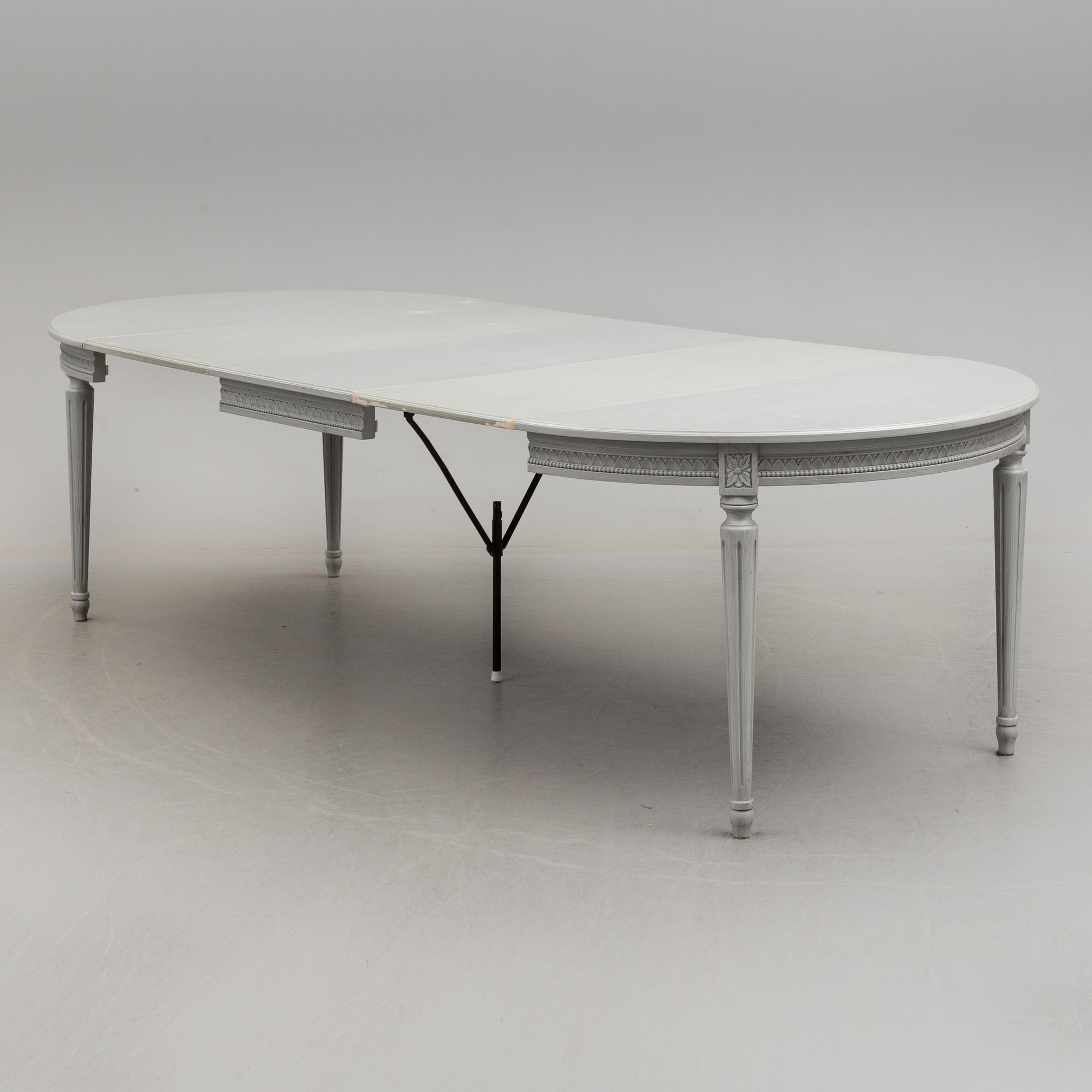 A Gustavian style dining table and ten chairs, 20th century.