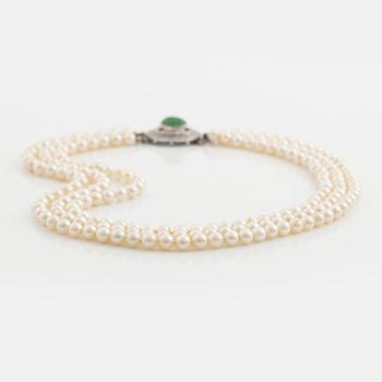 Three-row pearl necklace with cultured pearls, clasp with cabochon-cut emerald and brilliant-cut diamonds.