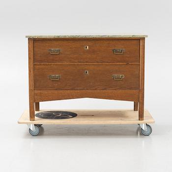 An oak and stone top chest of drawers, 1910's.