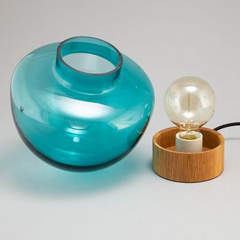 A glass and oak table light by Caroline Olsson for Magnor, Norway.