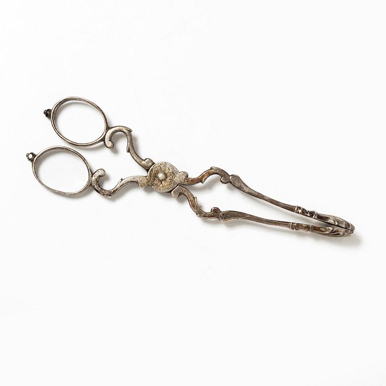 A pair of Swedish silver sugar tongs, mark of Isak Sauter, Stockholm, 1759. Rococo.