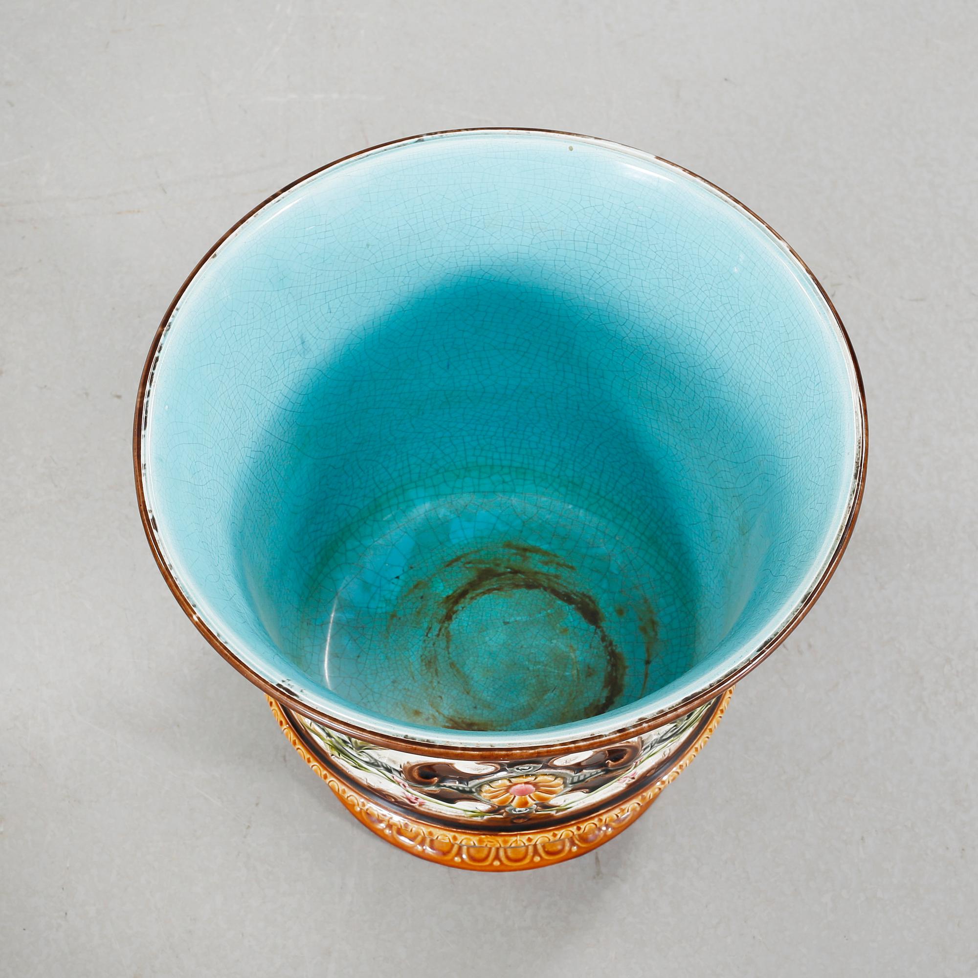 A Rörstrand pedestal with pot in majolica, made around year 1900.