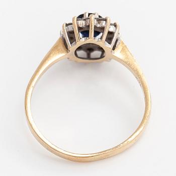 A 14K gold ring, with an oval faceted sapphire and diamonds, England.