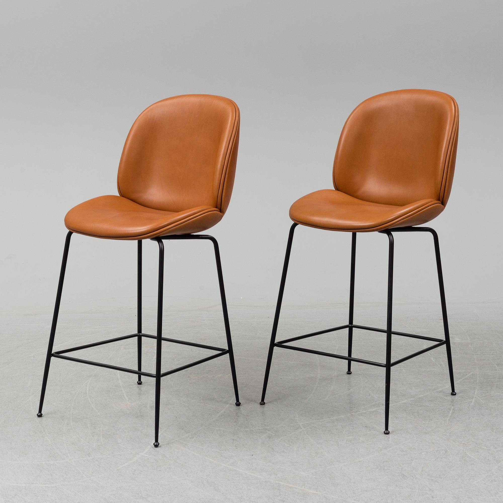 GAMFRATESI, a pair of 'Beetle Bar' leather chairs from GUBI.