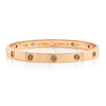 499. A Cartier "Love" bracelet in 18K rose gold set with colored stones.