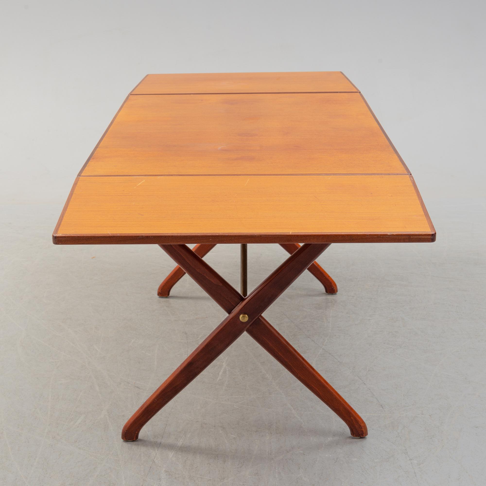 A teak veneer and stained beech dining table, mid 20th Century.